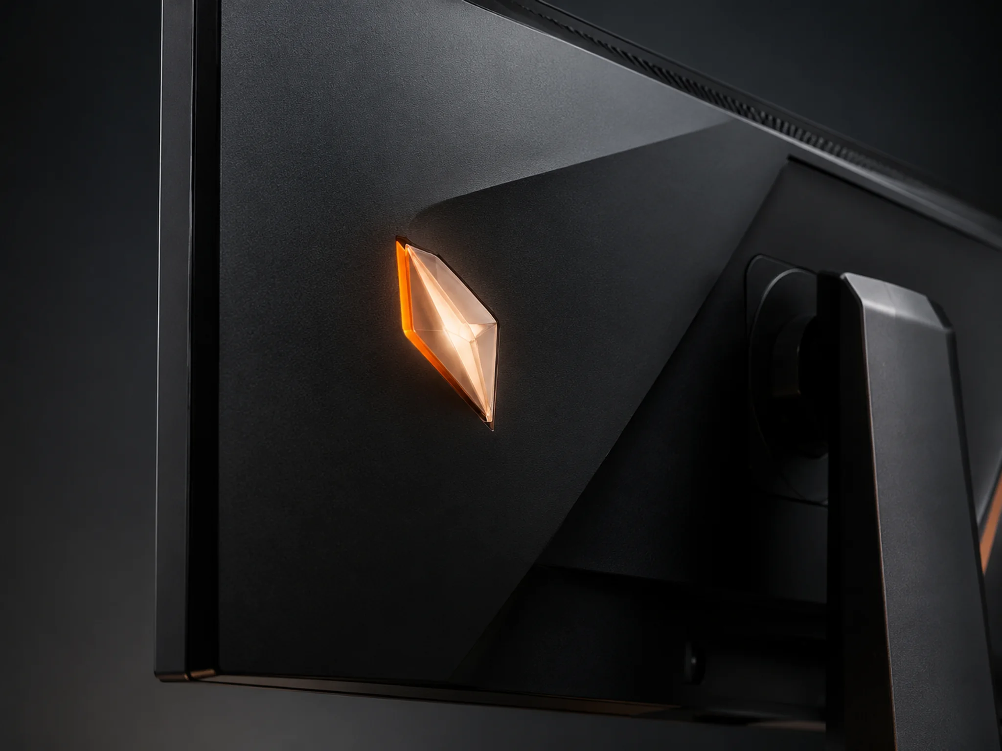 Warm illuminated logo window on the back of a gaming monitor