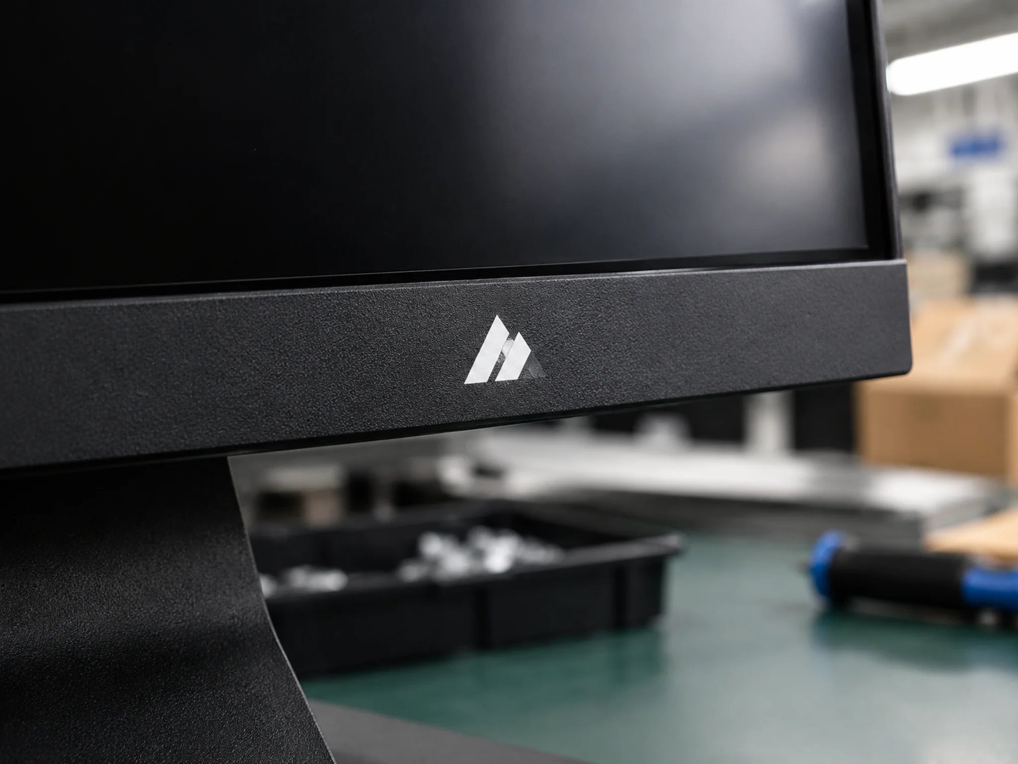 White screen-printed logo on a textured black monitor bezel