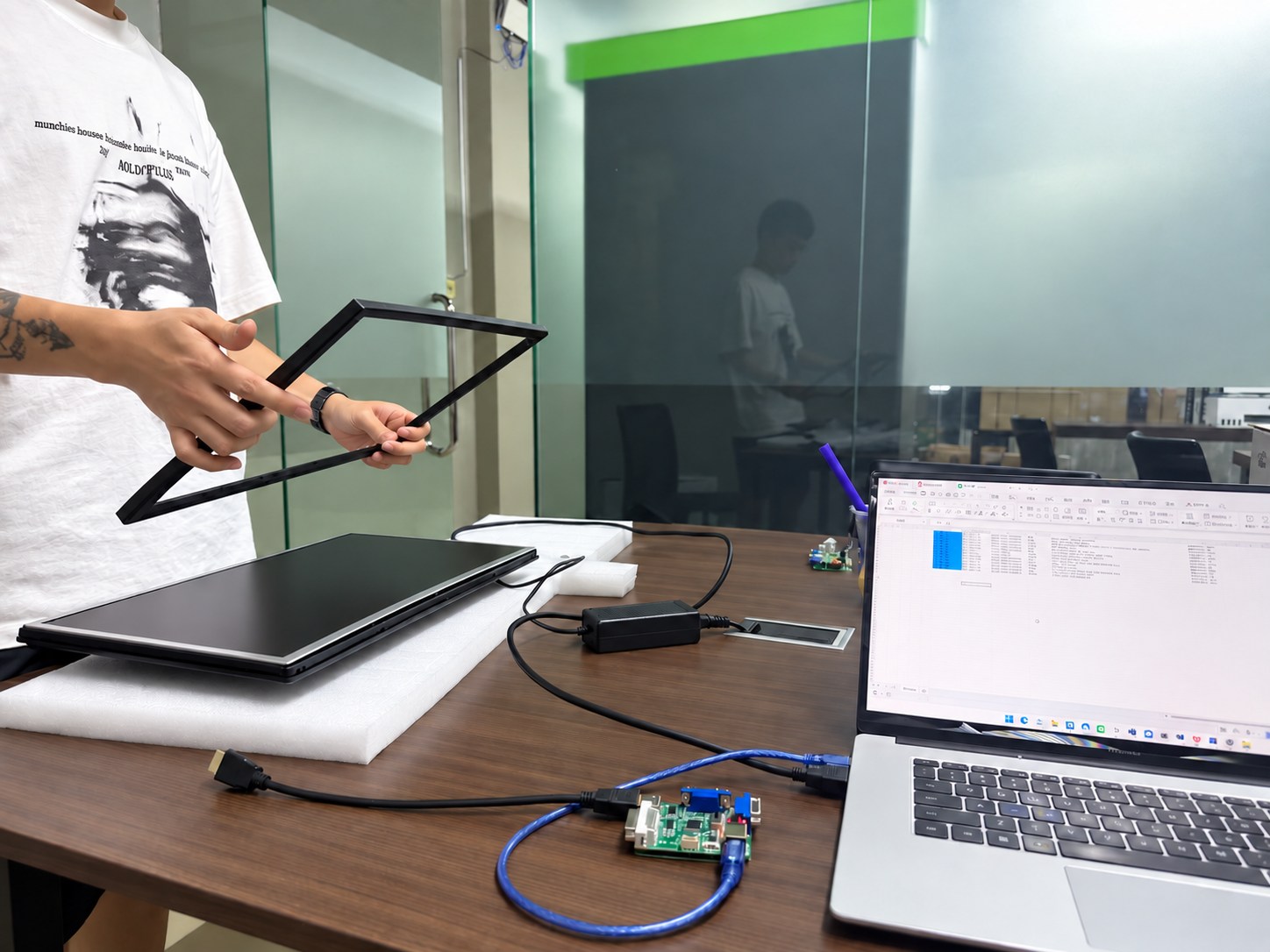 Technician preparing a monitor for warranty repair and diagnostic testing